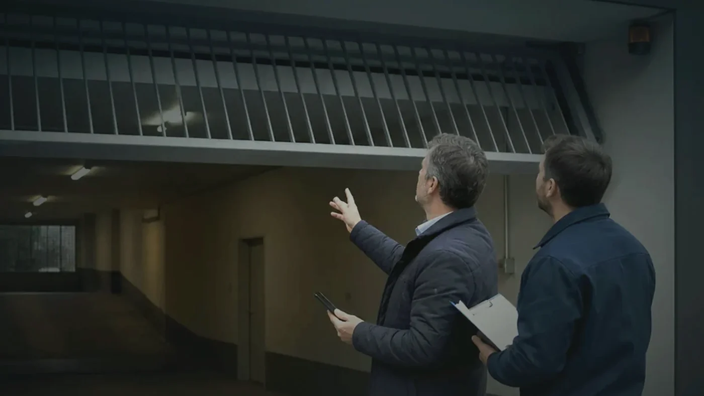 Technischer Serviceeinsatz in einer Sammelgarage in Wien Niederoesterreich mit Fokus auf Funkempfaenger, Antenne und Steuerungsschrank, realistische Servicefotografie ohne Logos oder Text im Bild